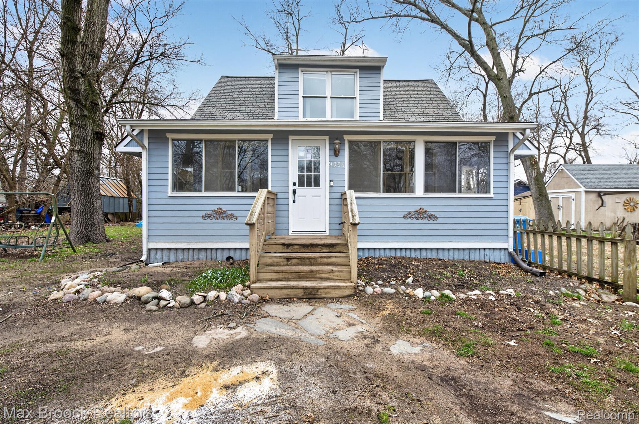 9024 Mandon Road White Lake, MI 48386 - Photo 1 of 39 Blue siding exterior with dormer window and white trim