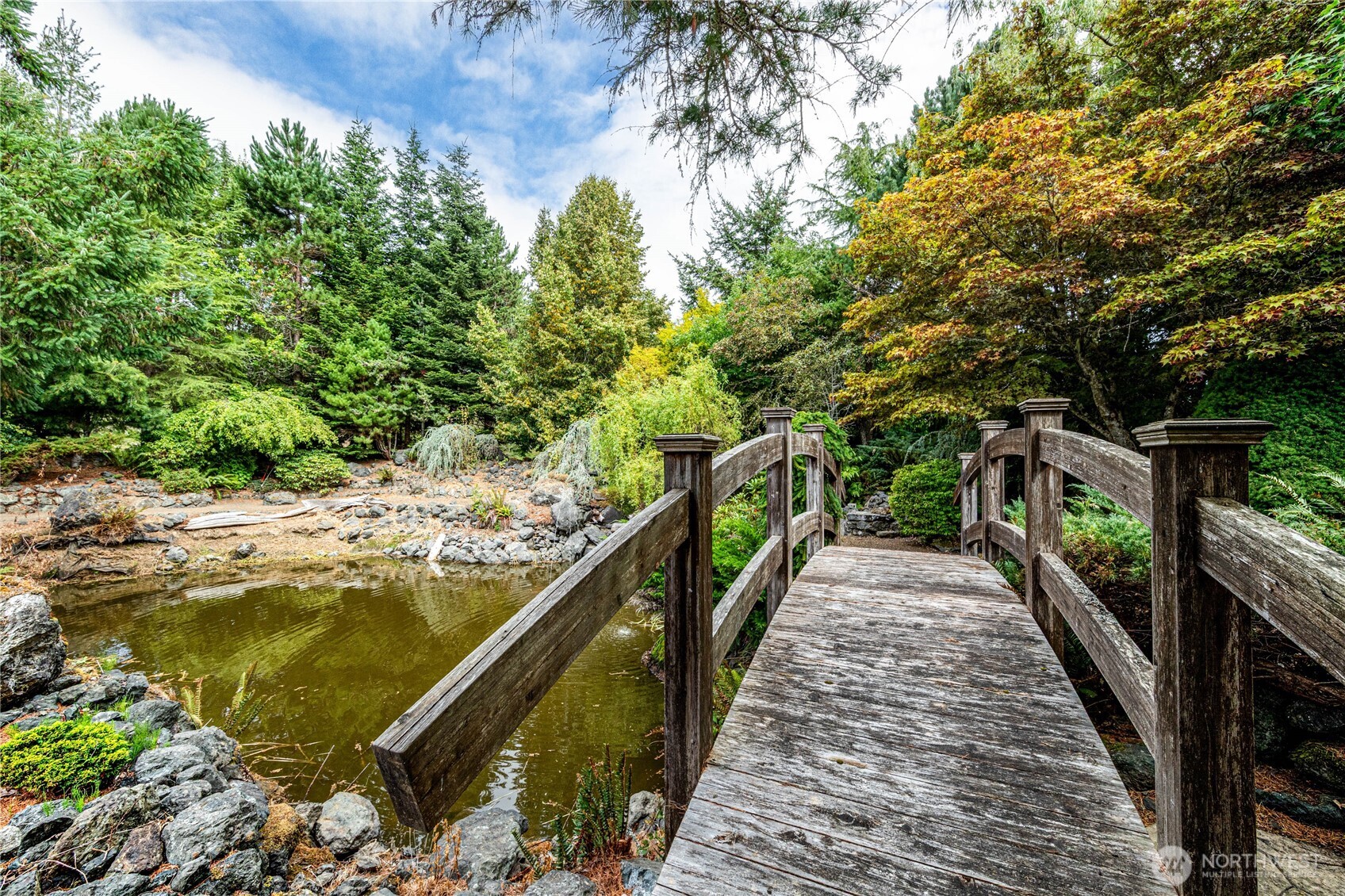62 Johnson Road Port Angeles, WA 98363 - Photo 33 of 38 a view of a lake with a floor to ceiling window and wooden fence
