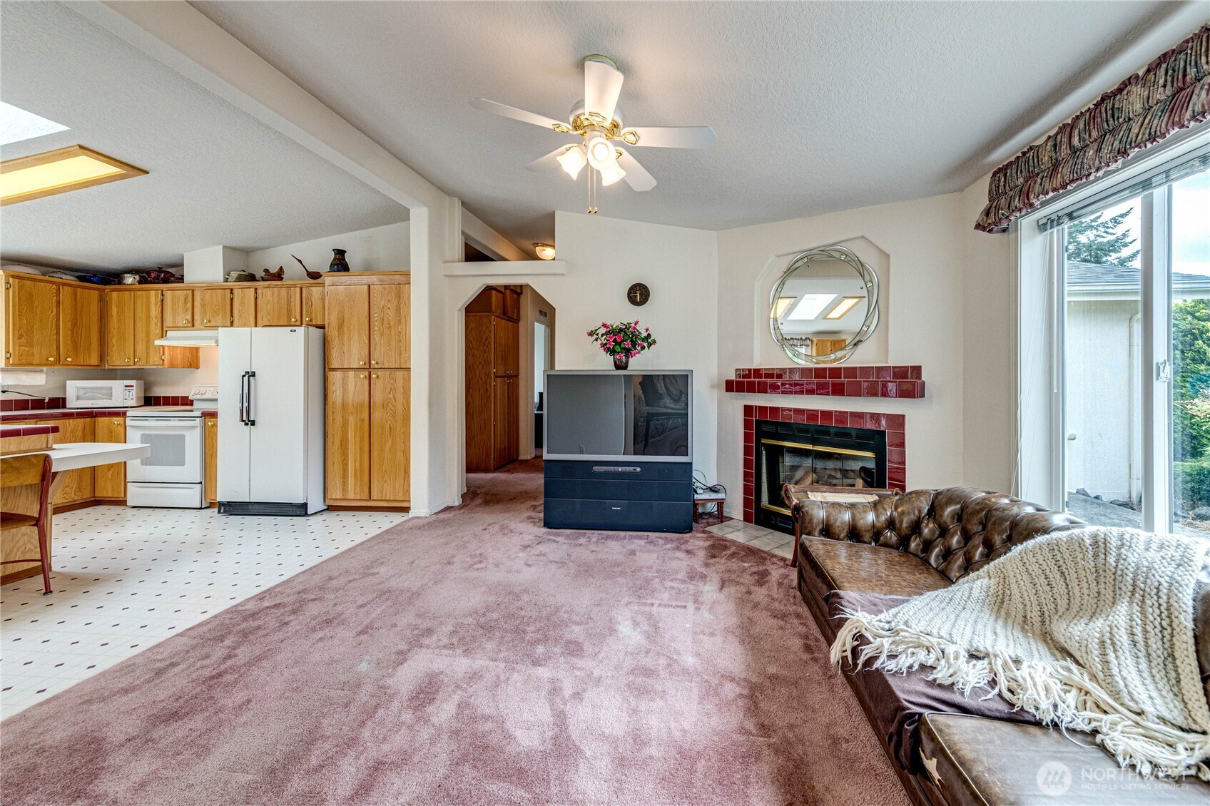 62 Johnson Road Port Angeles, WA 98363 - Photo 5 of 38 a living room with furniture a fireplace and a flat screen tv