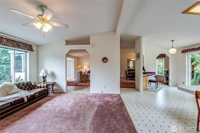a living room with furniture and a chandelier