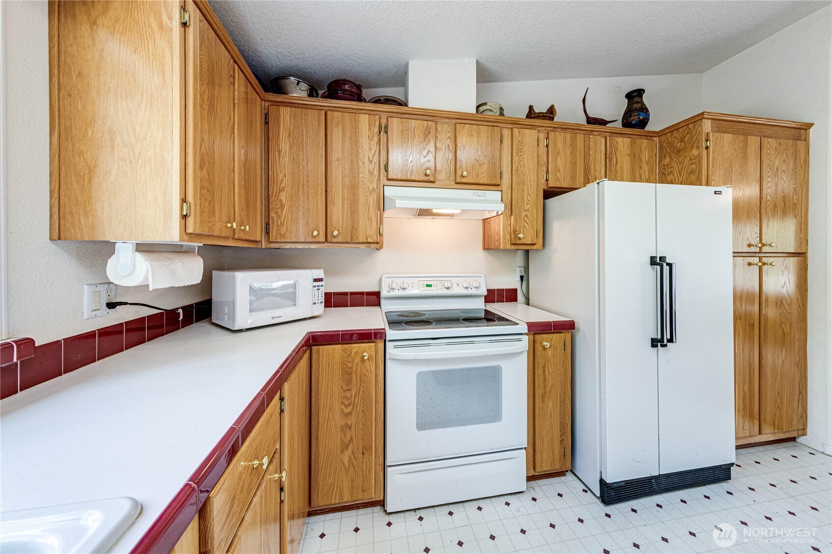 62 Johnson Road Port Angeles, WA 98363 - Photo 10 of 38 a kitchen with a refrigerator sink and cabinets