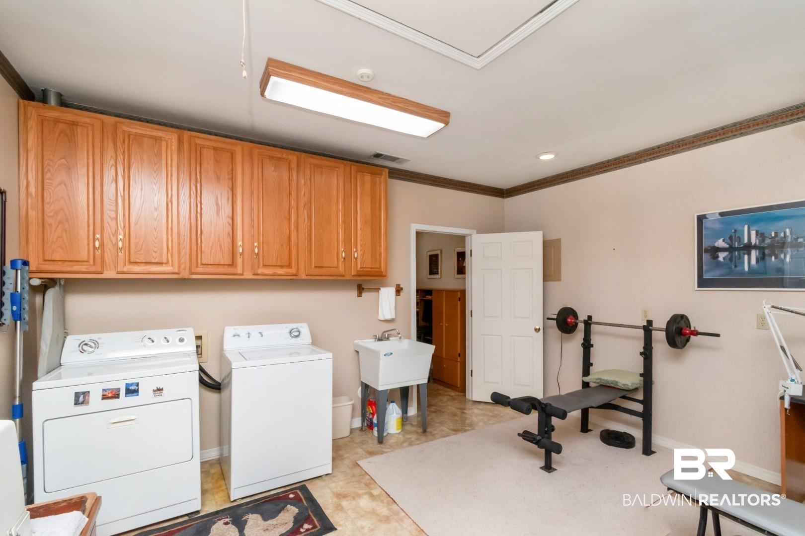 8220 Fordham Road Mobile, AL 36619 - Photo 24 of 41 Clothes washing area with washing machine and dryer, baseboards, visible vents, crown molding, and cabinet space