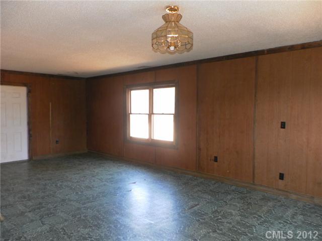 7296 Shiloh Unity Road Lancaster, SC 29720 - Photo 9 of 9 wooden floor in an empty room with a window