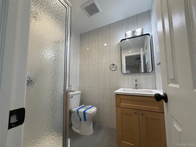 an open kitchen with kitchen island a sink dishwasher a stove and a refrigerator with wooden floor