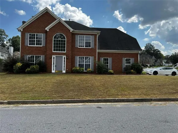 a front view of a house with a yard