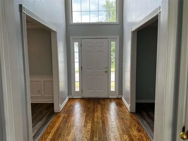 a view of front door deck with wooden floor