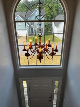 a view of a room with filled window and furniture
