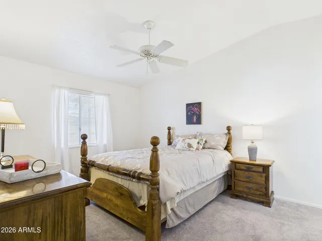 a spacious bedroom with a bed and a table