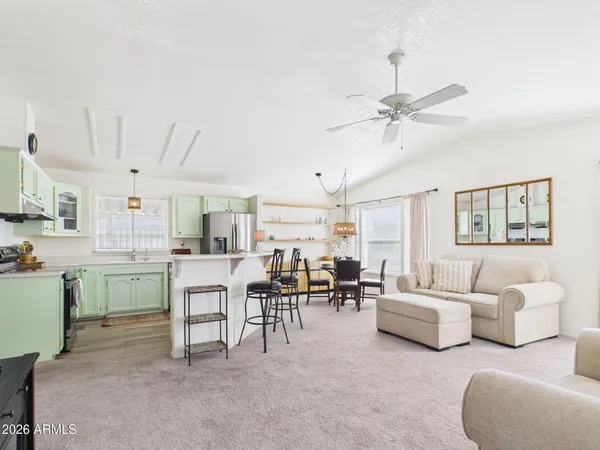 a living room with lots of furniture and white walls