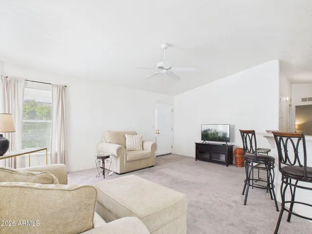 a living room with furniture and a large window