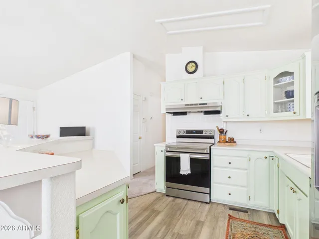 a kitchen with cabinets stainless steel appliances and a sink