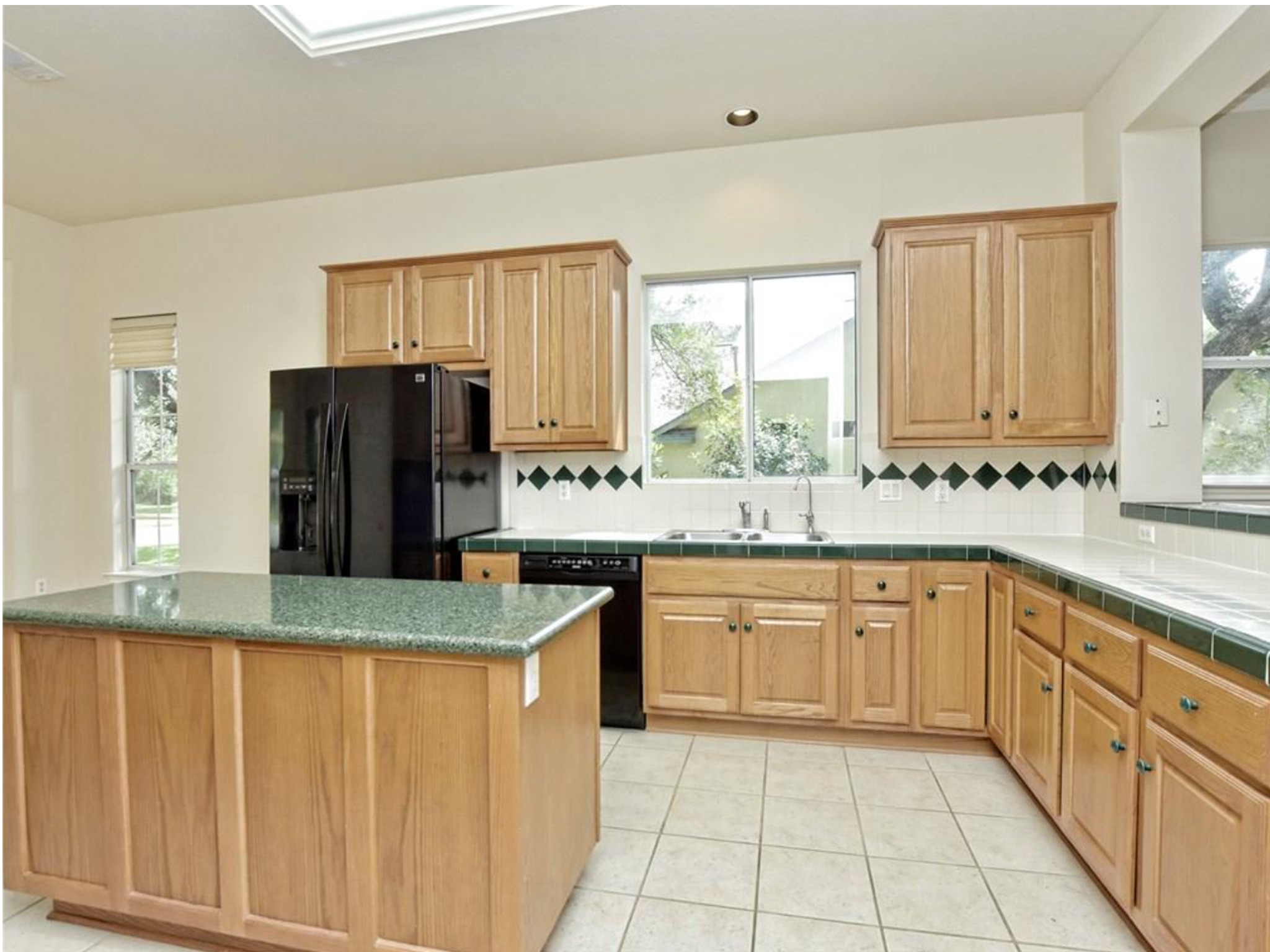 168 Dan Moody Trail Georgetown, TX 78633 - Photo 15 of 40 a large kitchen with granite countertop a sink window and refrigerator