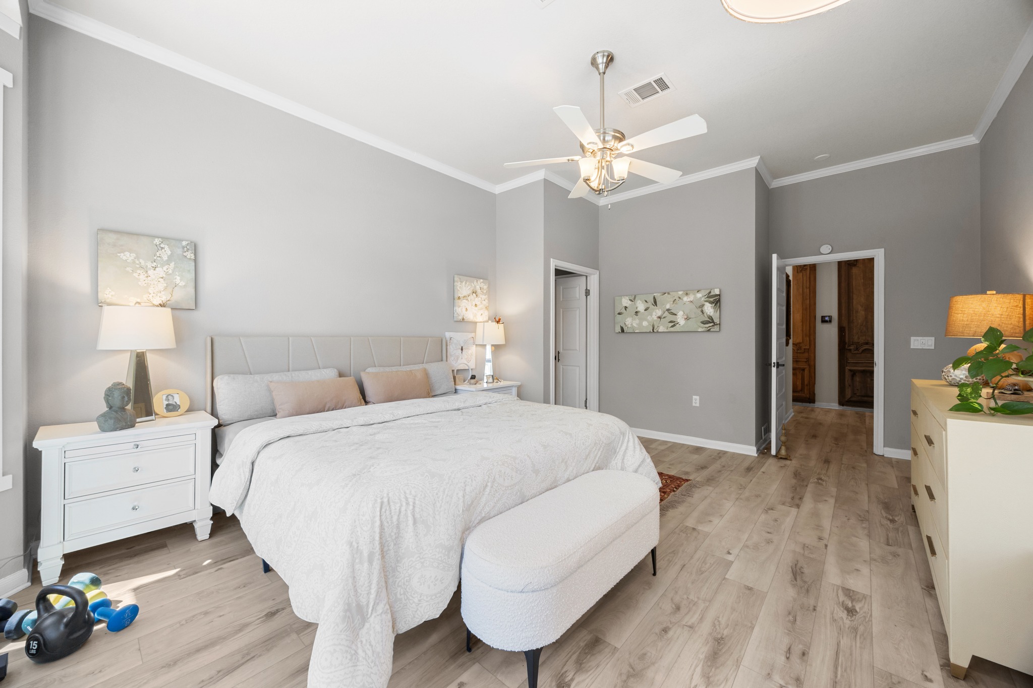 168 Dan Moody Trail Georgetown, TX 78633 - Photo 26 of 40 a spacious bedroom with a bed and a chandelier