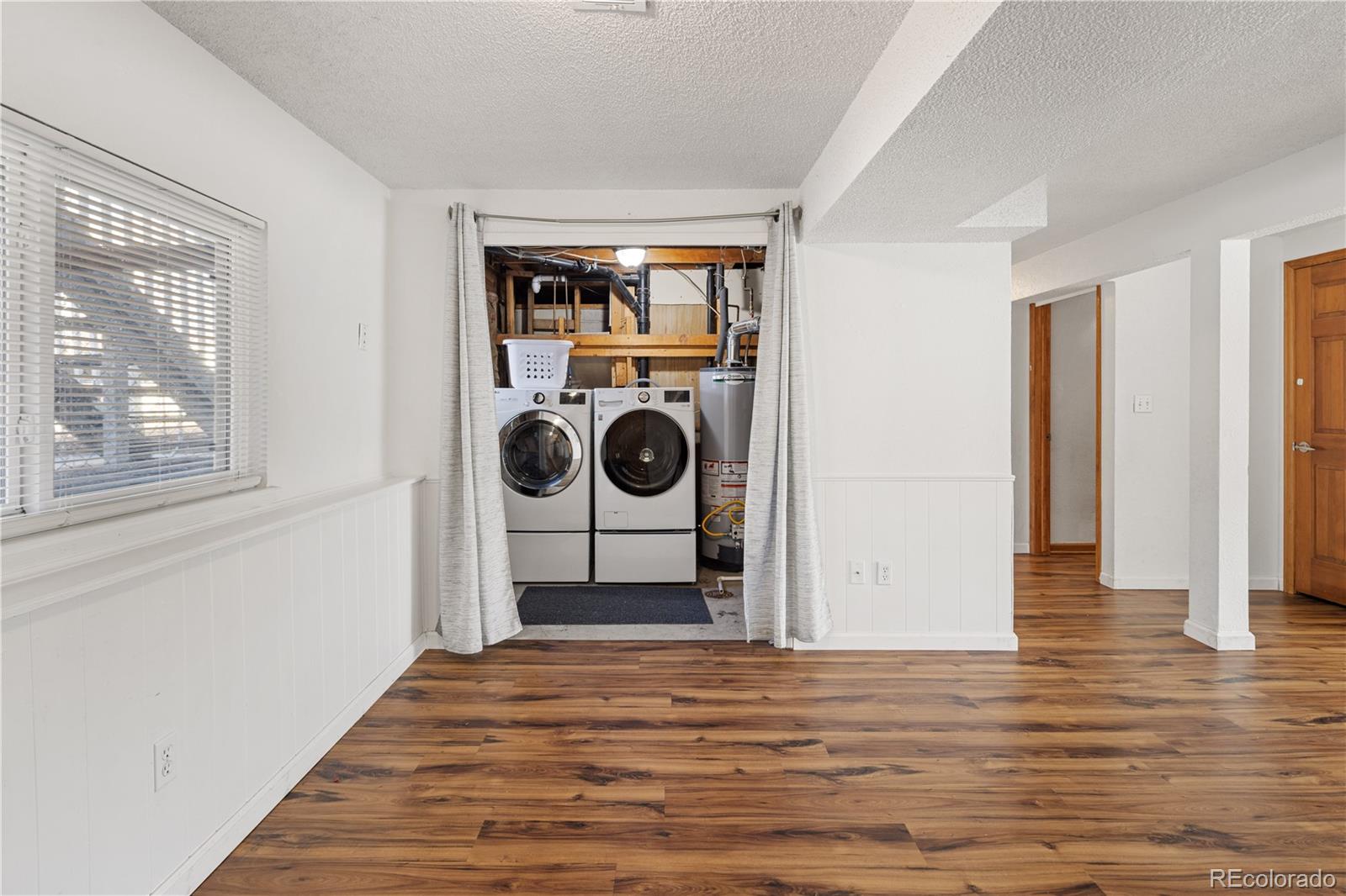 4615 Quail Street Wheat Ridge, CO 80033 - Photo 16 of 29 a view of a hallway with wooden floor and closet