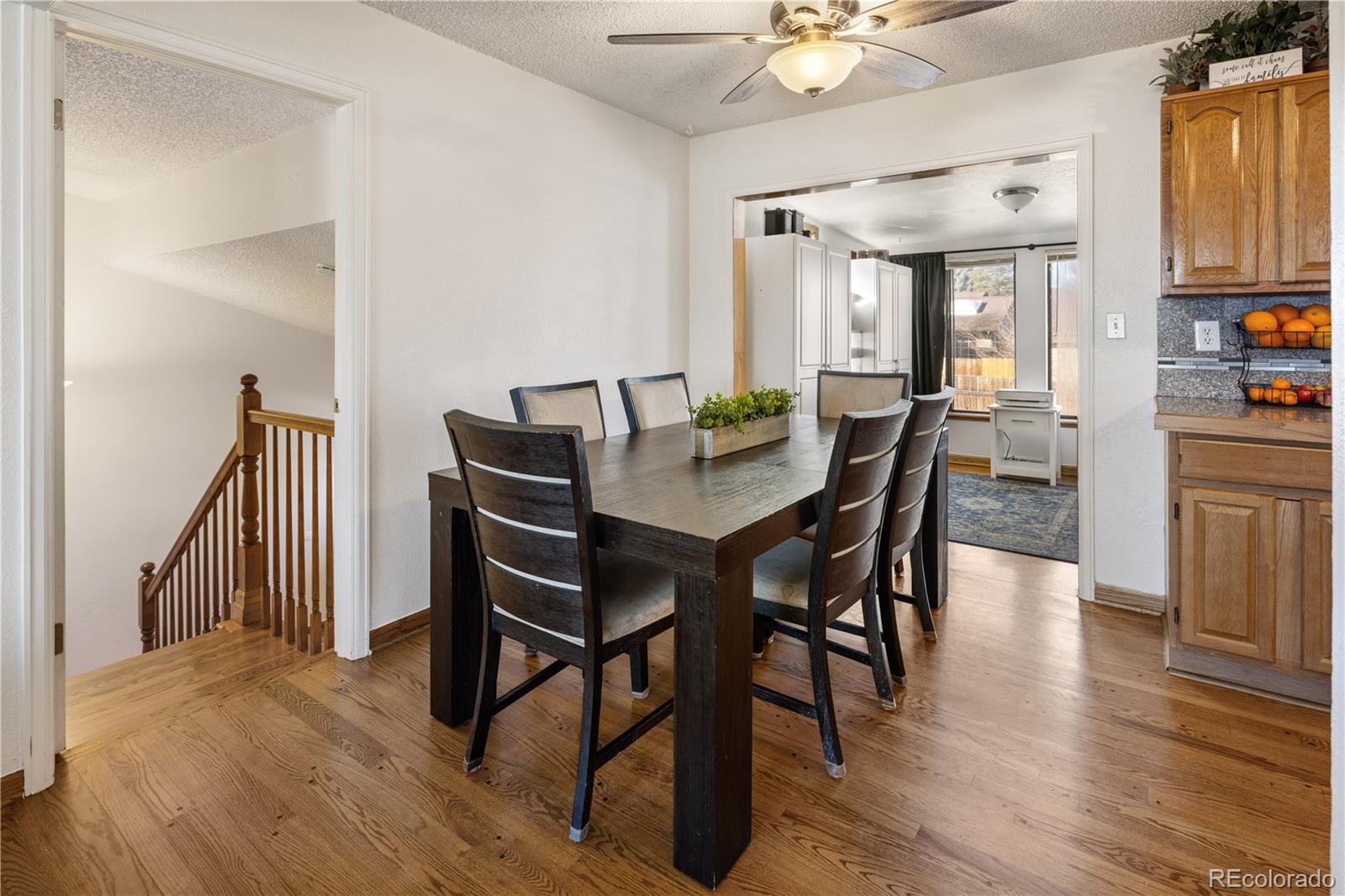 4615 Quail Street Wheat Ridge, CO 80033 - Photo 5 of 29 a view of a dining room with furniture and wooden floor