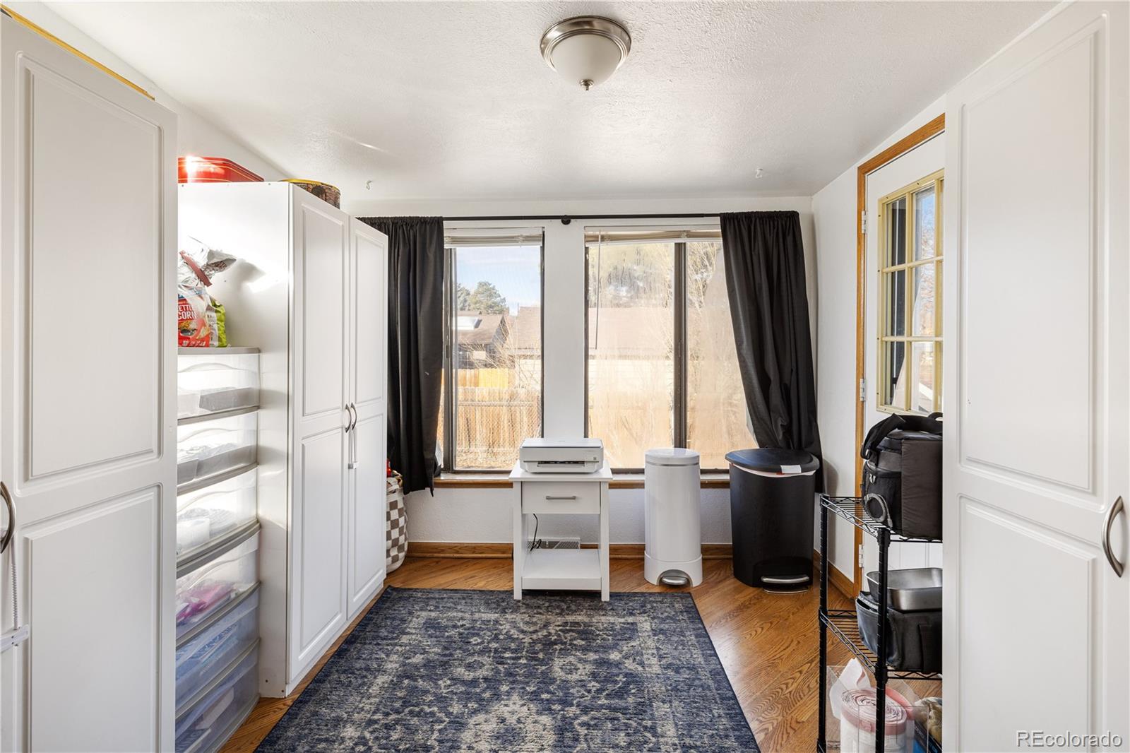 4615 Quail Street Wheat Ridge, CO 80033 - Photo 9 of 29 a view of workspace with wooden floor and windows