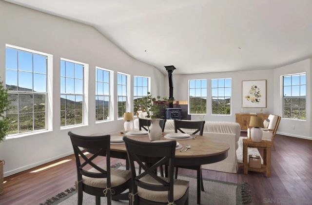 a living room with furniture and a flat screen tv with wooden floor