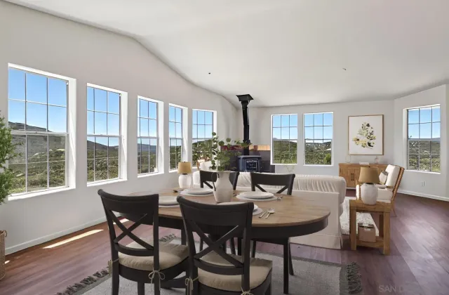 a living room with furniture and a flat screen tv with wooden floor