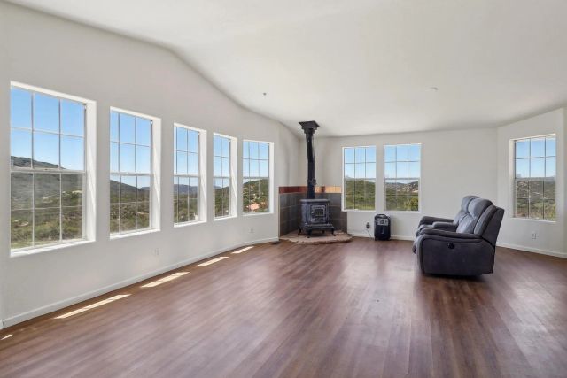 a living room with furniture and a floor to ceiling window