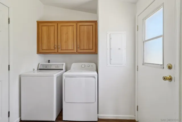 a spacious bedroom with a bed and wooden floor