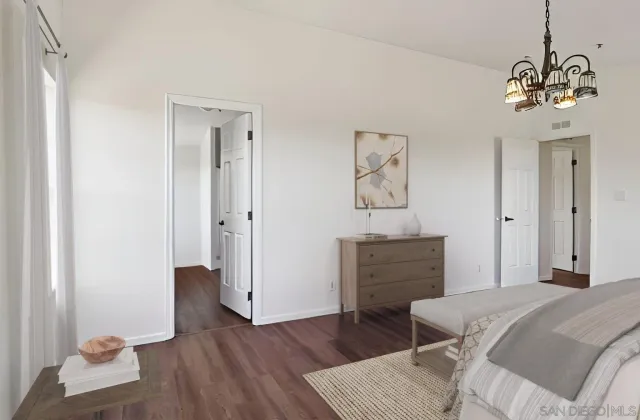 a view of a room with wooden floor and a window