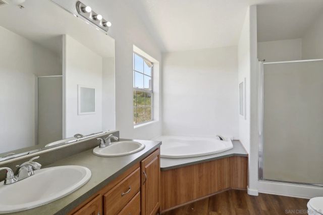a bathroom with a granite countertop bathtub and toilet