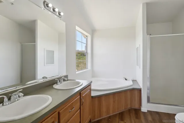 a bathroom with a granite countertop bathtub and toilet