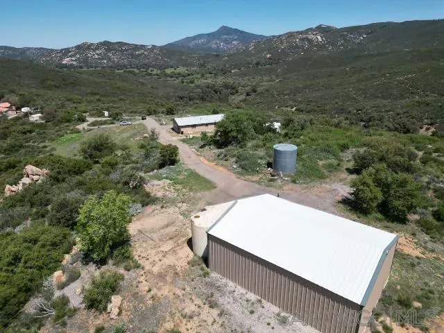 a view of a house with a mountain and a forest