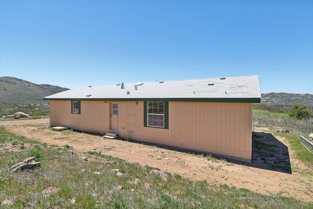 a view of a mountain range with lush green forest