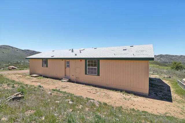 a view of a mountain range with lush green forest