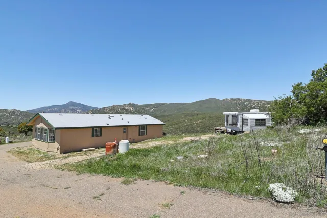 a view of a house with a backyard