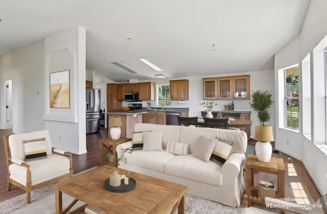 a living room with furniture a kitchen view and a fireplace