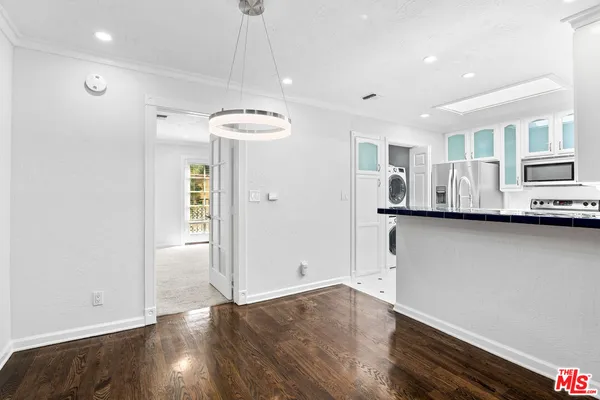 a view of a kitchen with a sink and dishwasher wooden floor