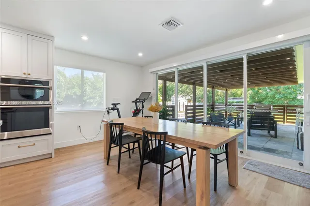 a large kitchen with a table and chairs