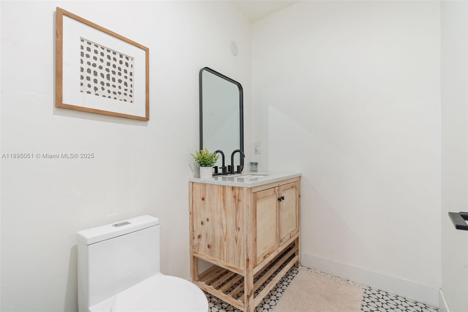 8121 Southwest 97th Terrace Miami, FL 33156 - Photo 33 of 38 a bathroom with a toilet a sink and mirror