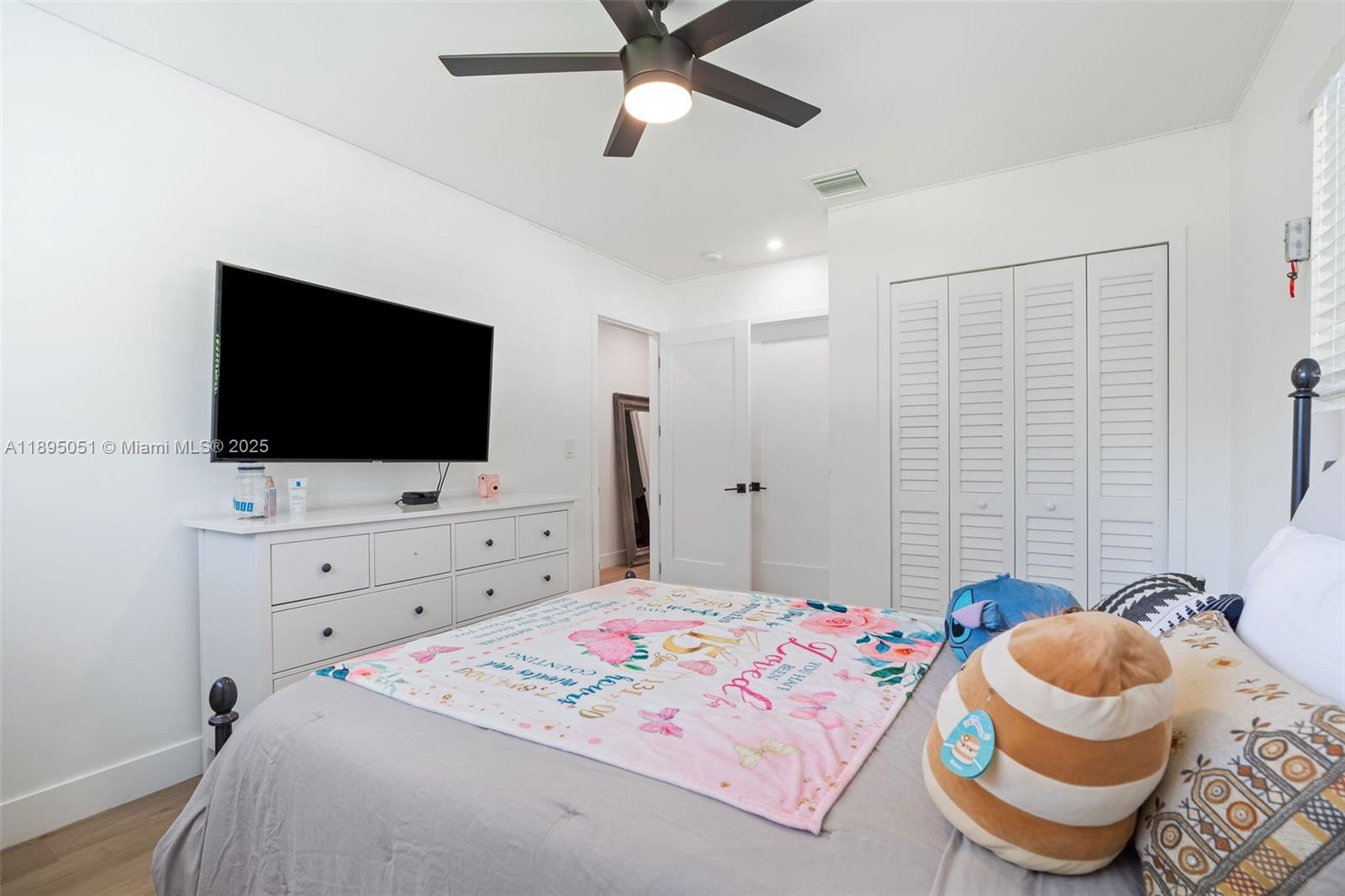 8121 Southwest 97th Terrace Miami, FL 33156 - Photo 34 of 38 a bedroom with a bed and a flat screen tv