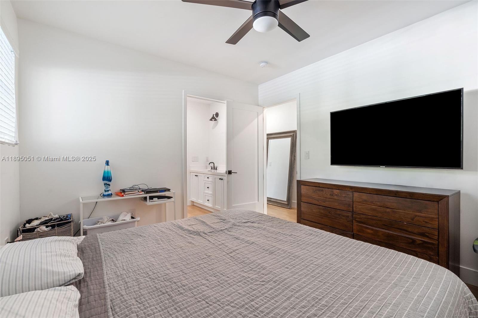 8121 Southwest 97th Terrace Miami, FL 33156 - Photo 35 of 38 a bedroom with a bed and a flat screen tv