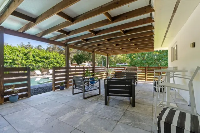 a view of a chairs and bench in the room
