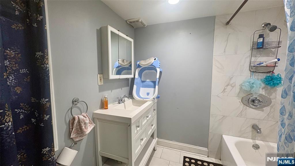 17 Cleveland Avenue, Unit 2 Harrison, NJ 07029 - Photo 11 of 12 a bathroom with a sink a toilet and shower