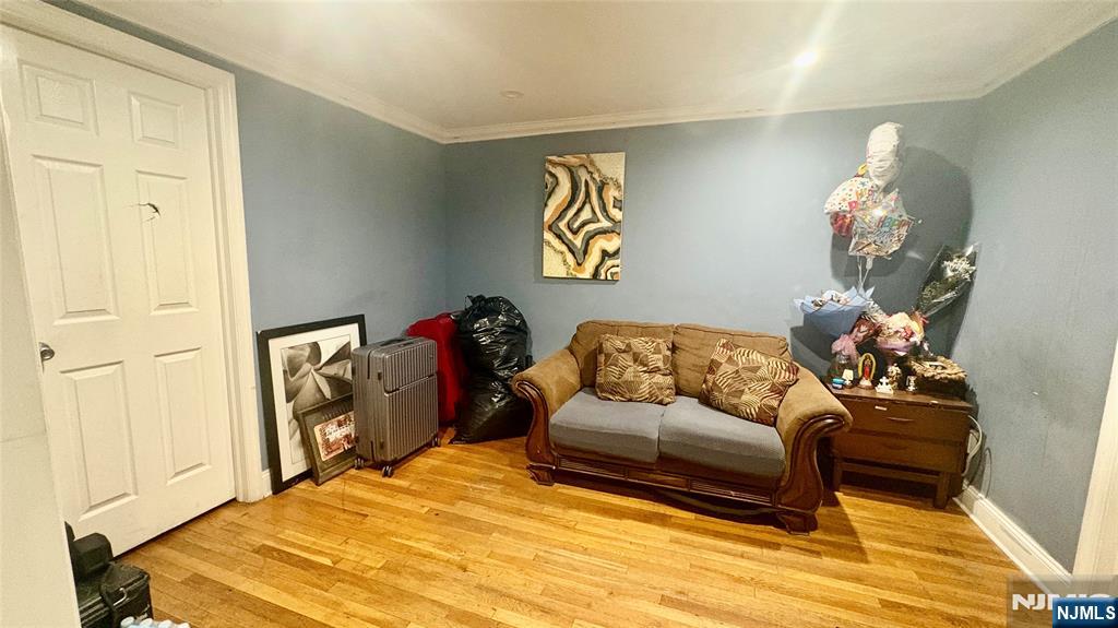 17 Cleveland Avenue, Unit 2 Harrison, NJ 07029 - Photo 2 of 12 a bedroom with a bed and a chandelier