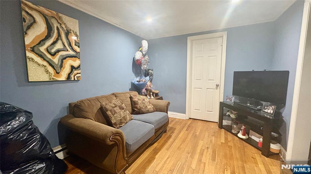 17 Cleveland Avenue, Unit 2 Harrison, NJ 07029 - Photo 3 of 12 a living room with furniture and a flat screen tv