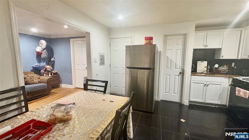 17 Cleveland Avenue, Unit 2 Harrison, NJ 07029 - Photo 6 of 12 a kitchen with stainless steel appliances a refrigerator sink and stove