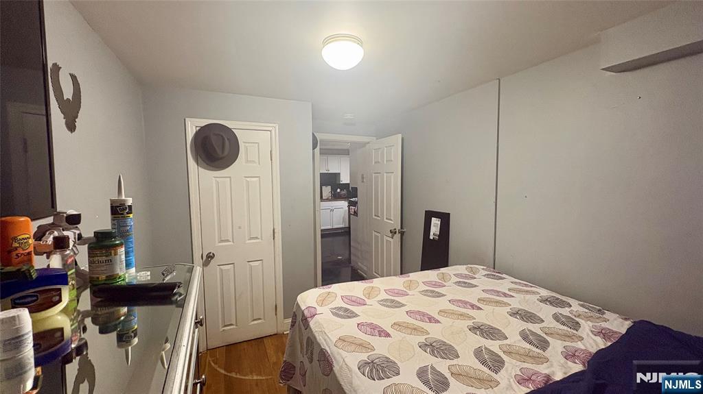 17 Cleveland Avenue, Unit 2 Harrison, NJ 07029 - Photo 8 of 12 a bedroom with a bed and a mirror