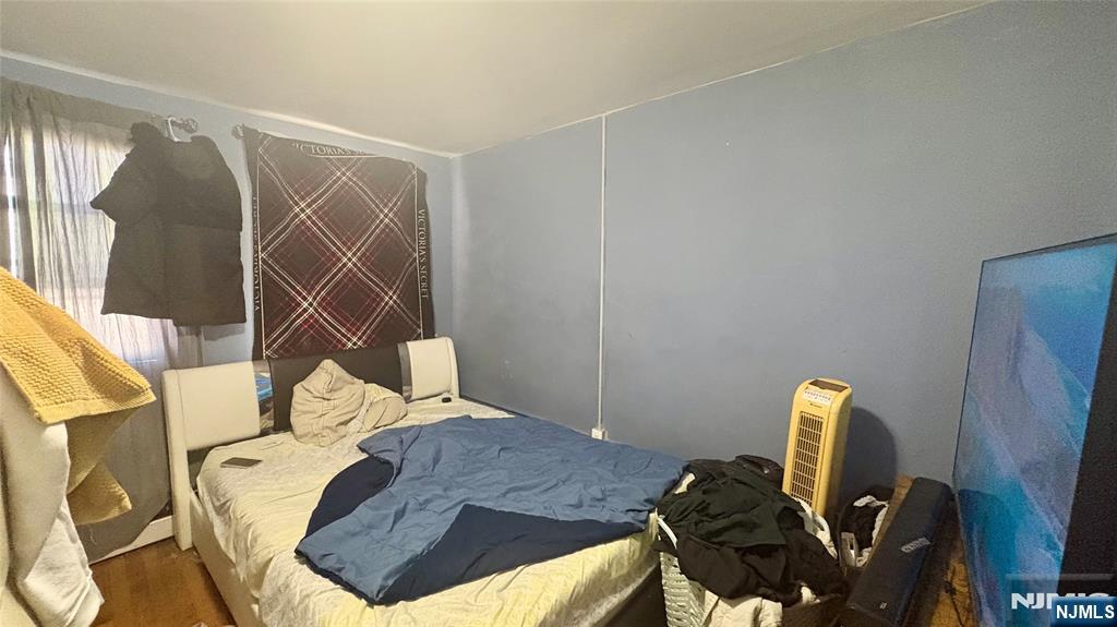 17 Cleveland Avenue, Unit 2 Harrison, NJ 07029 - Photo 9 of 12 a bedroom with a bed and a desk