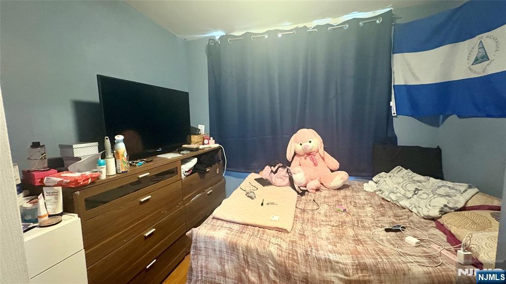 17 Cleveland Avenue, Unit 2 Harrison, NJ 07029 - Photo 10 of 12 a bed room with a bed and a television