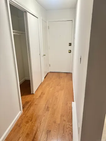 a view of hallway with wooden floor
