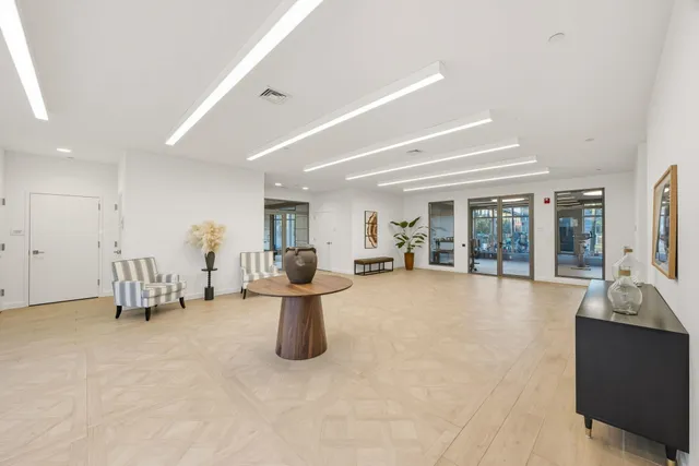 a living room with furniture and large windows