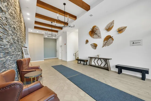 a bedroom with furniture and a rug