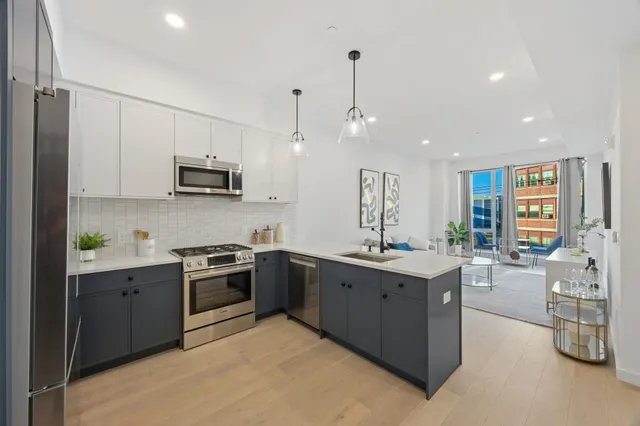 a kitchen with stainless steel appliances granite countertop a sink and stove top oven