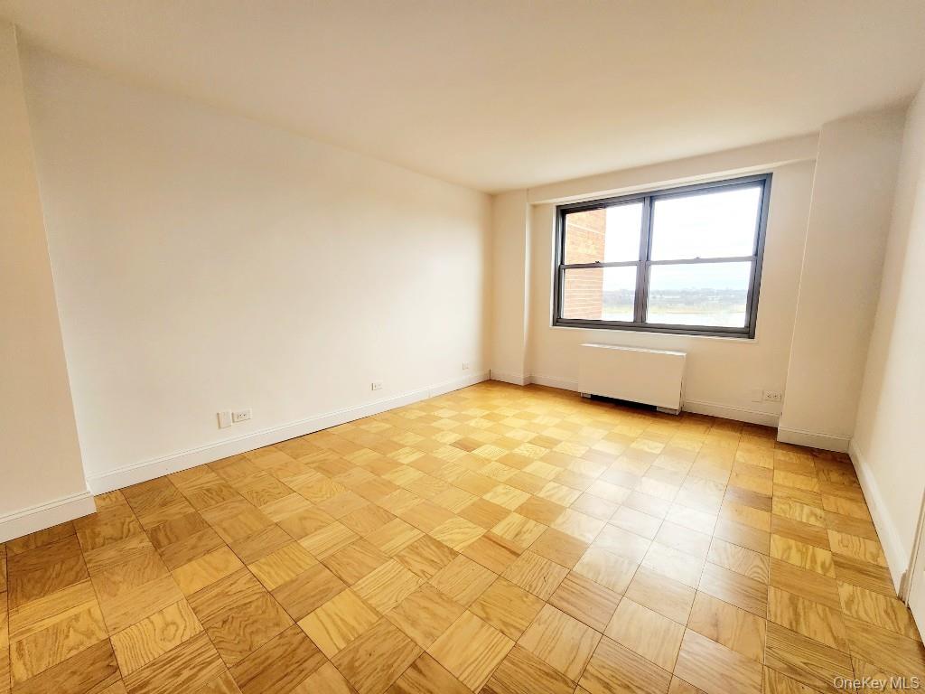 61-20 Grand Central Parkway, Unit A1406 Queens, NY 11375 - Photo 22 of 23 a view of an empty room with a window